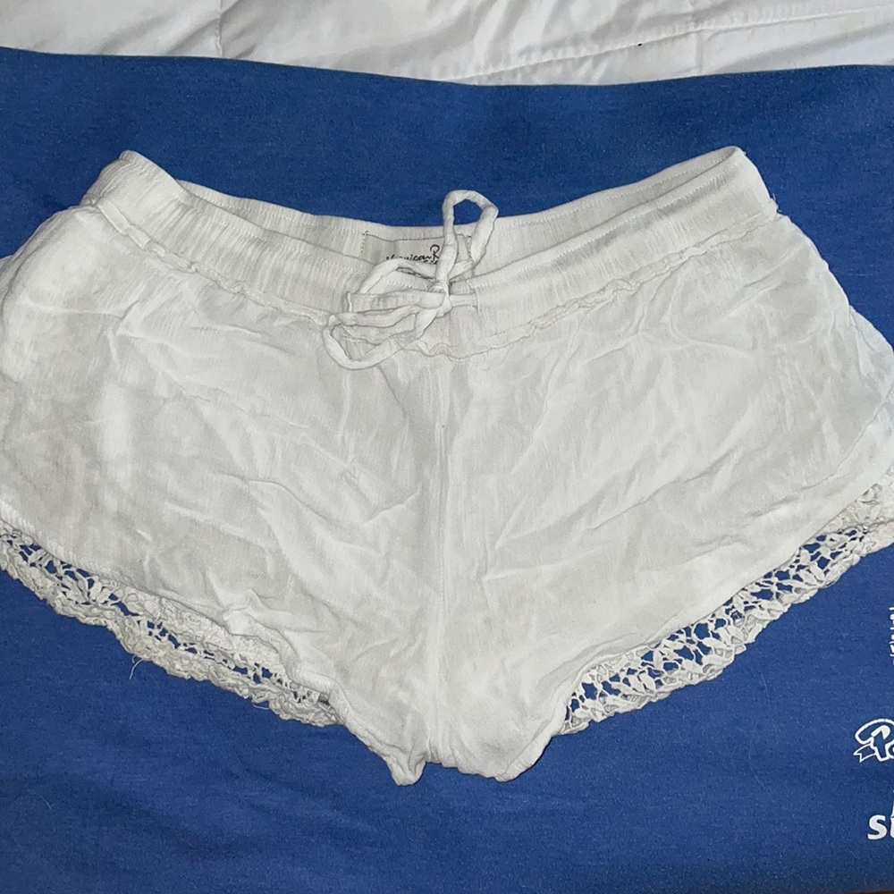Flowy white shorts with lace on the sides